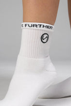 Front View of White TLF Evolve Half Crew Socks featuring an embroidered TLF logo and interiors take life further stitched detailing with a cushioned footbed
