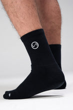 Side View of Black the TLF Evolve Half Crew Socks featuring an embroidered TLF logo and interiors take life further stitched detailing with a cushioned footbed