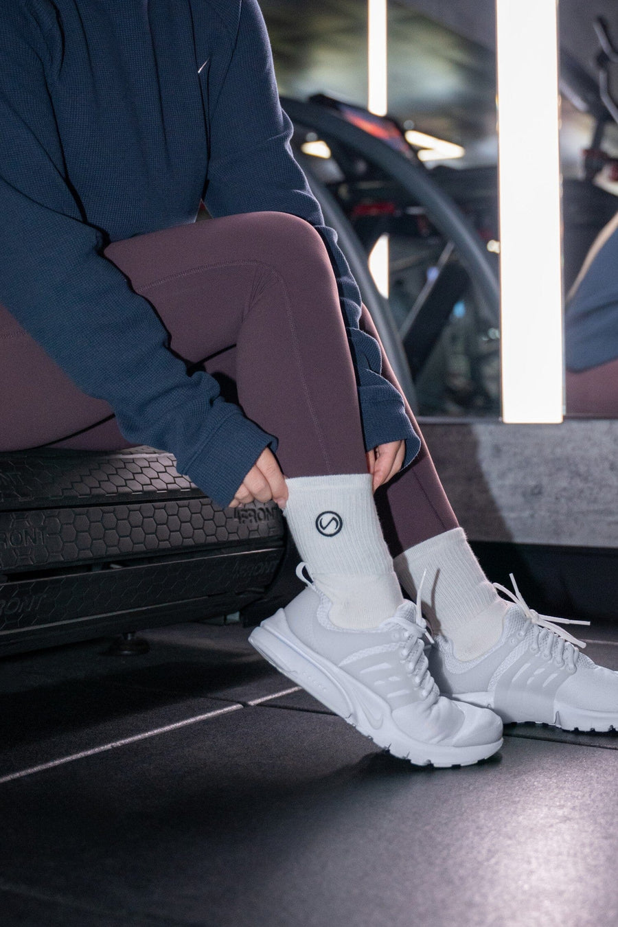Front View of Black and WhiteTLF Evolve Half Crew Socks featuring an embroidered TLF logo and interiors take life further stitched detailing with a cushioned footbed