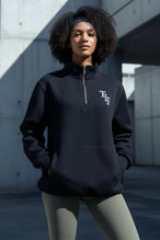 Front View of Black TLF GTS Scuba Tech Quarter-Zip Pullover, featuring a ¼ zip pullover, sleek design and kangaroo pockets 