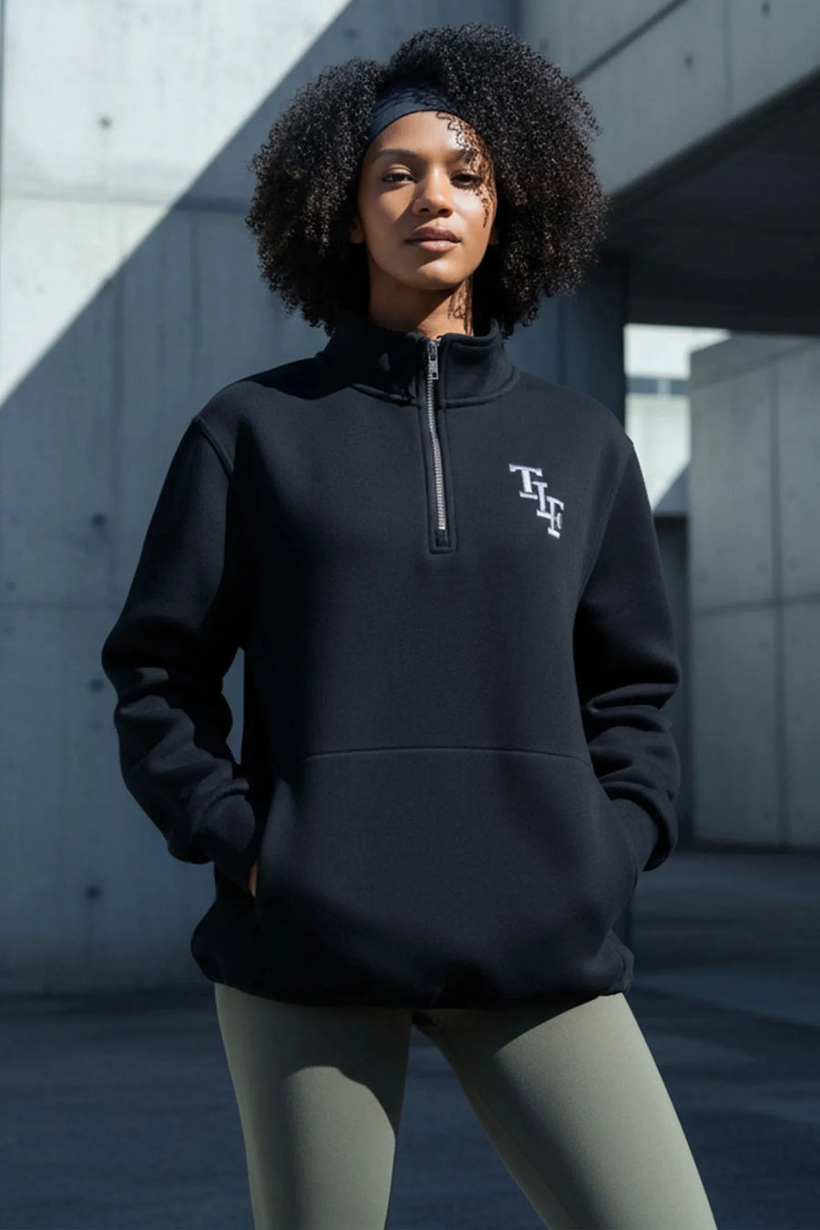 Front View of Black TLF GTS Scuba Tech Quarter-Zip Pullover, featuring a ¼ zip pullover, sleek design and kangaroo pockets 