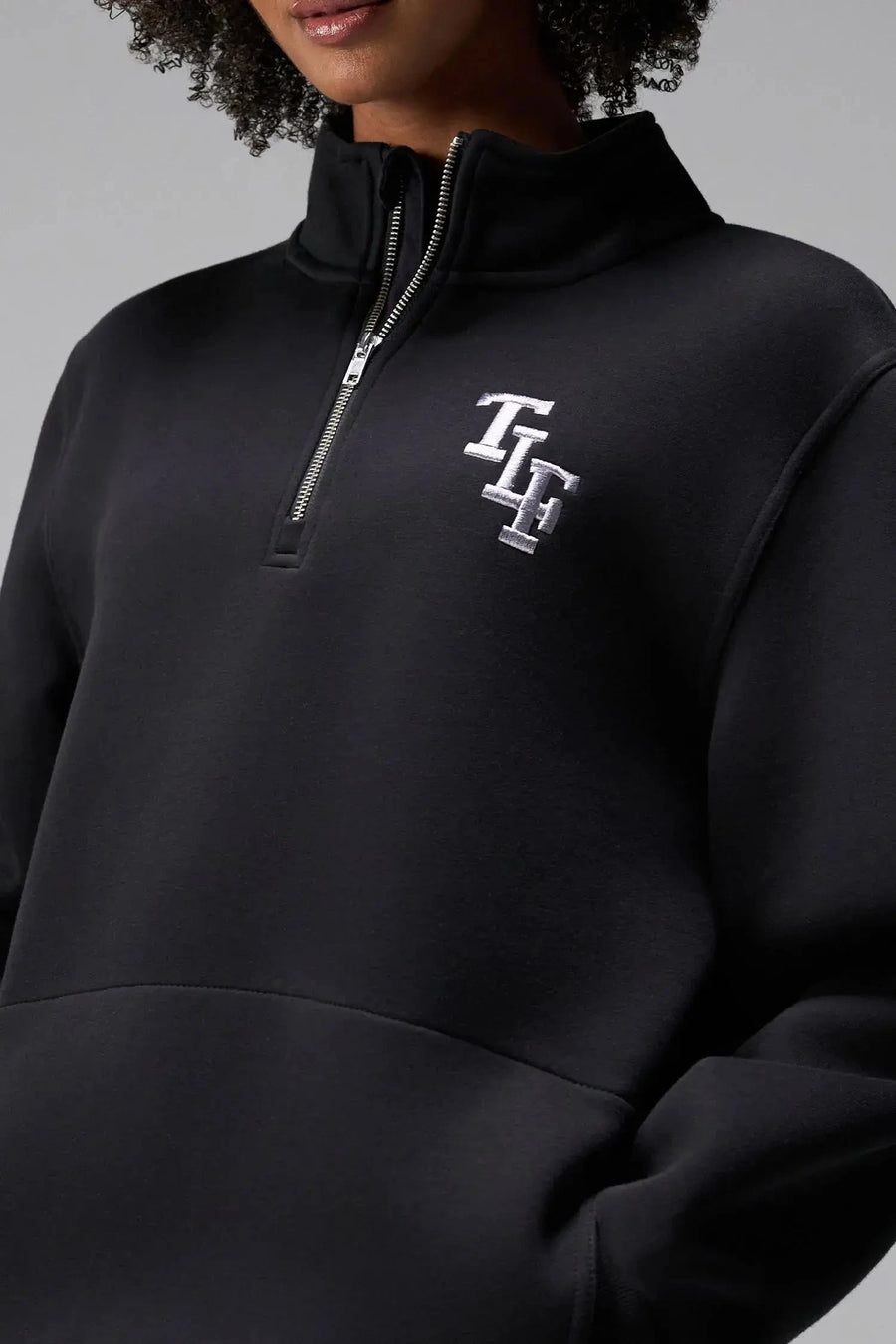  Front View of Black TLF GTS Scuba Tech Quarter-Zip Pullover, featuring a ¼ zip pullover, sleek design and kangaroo pockets 
