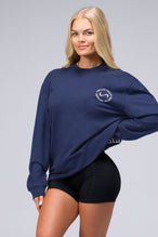 Front View of Blue the TLF Redefine Original Cotton Luxe Oversized LS Tee that features a bold back graphic in an oversized fit. 