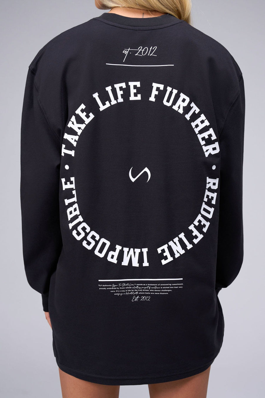 Back View of Black the TLF Redefine Original Cotton Luxe Oversized LS Tee that features a bold back graphic in an oversized fit. 