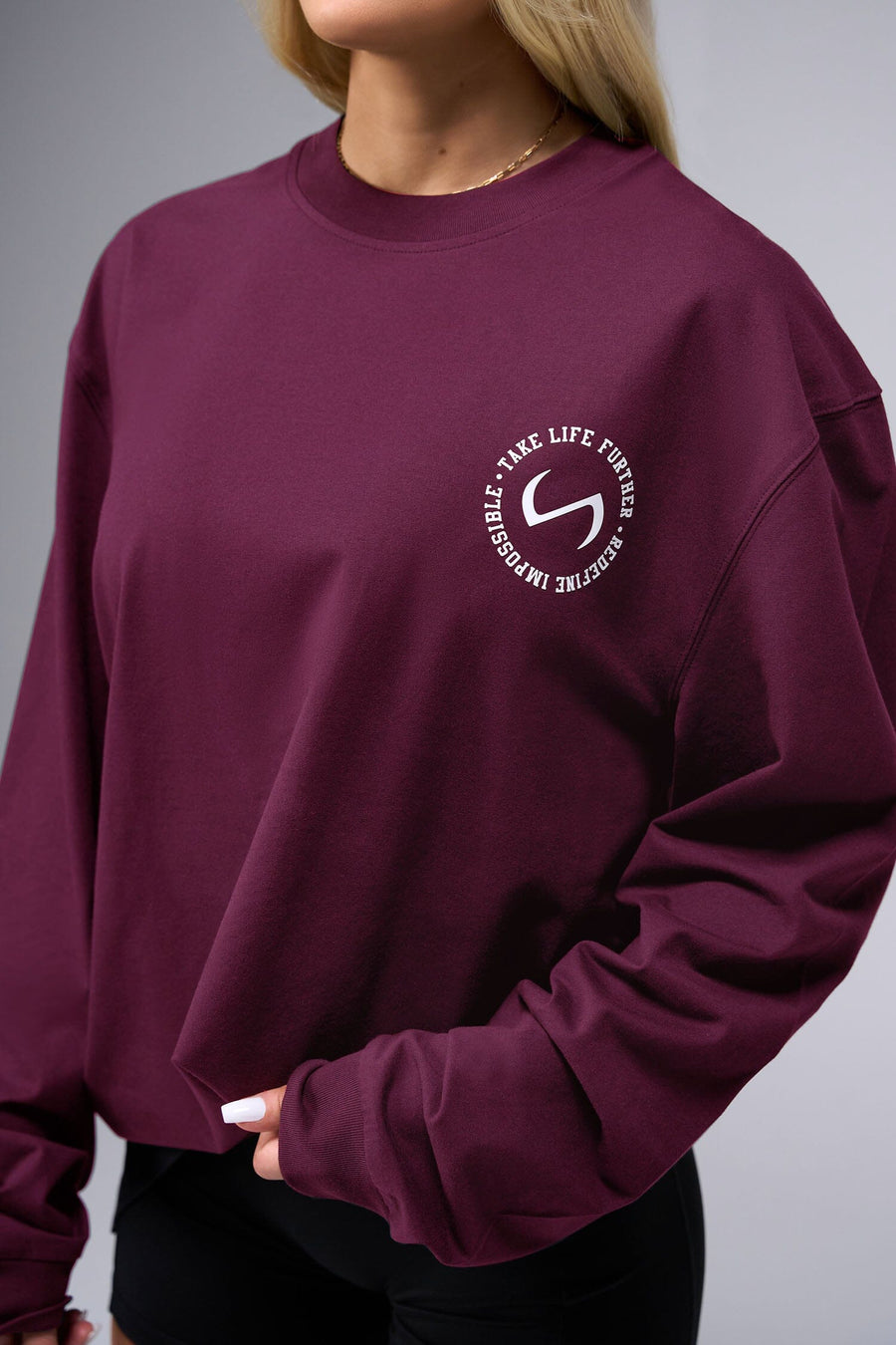 Front View of Red the TLF Redefine Original Cotton Luxe Oversized LS Tee that features a bold back graphic in an oversized fit. 