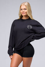 Front View of Black the TLF Redefine Original Cotton Luxe Oversized LS Tee that features a bold back graphic in an oversized fit. 