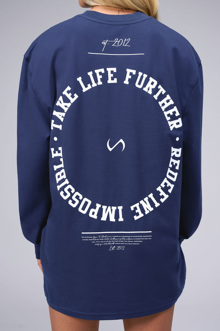 Back View of Blue the TLF Redefine Original Cotton Luxe Oversized LS Tee that features a bold back graphic in an oversized fit. 