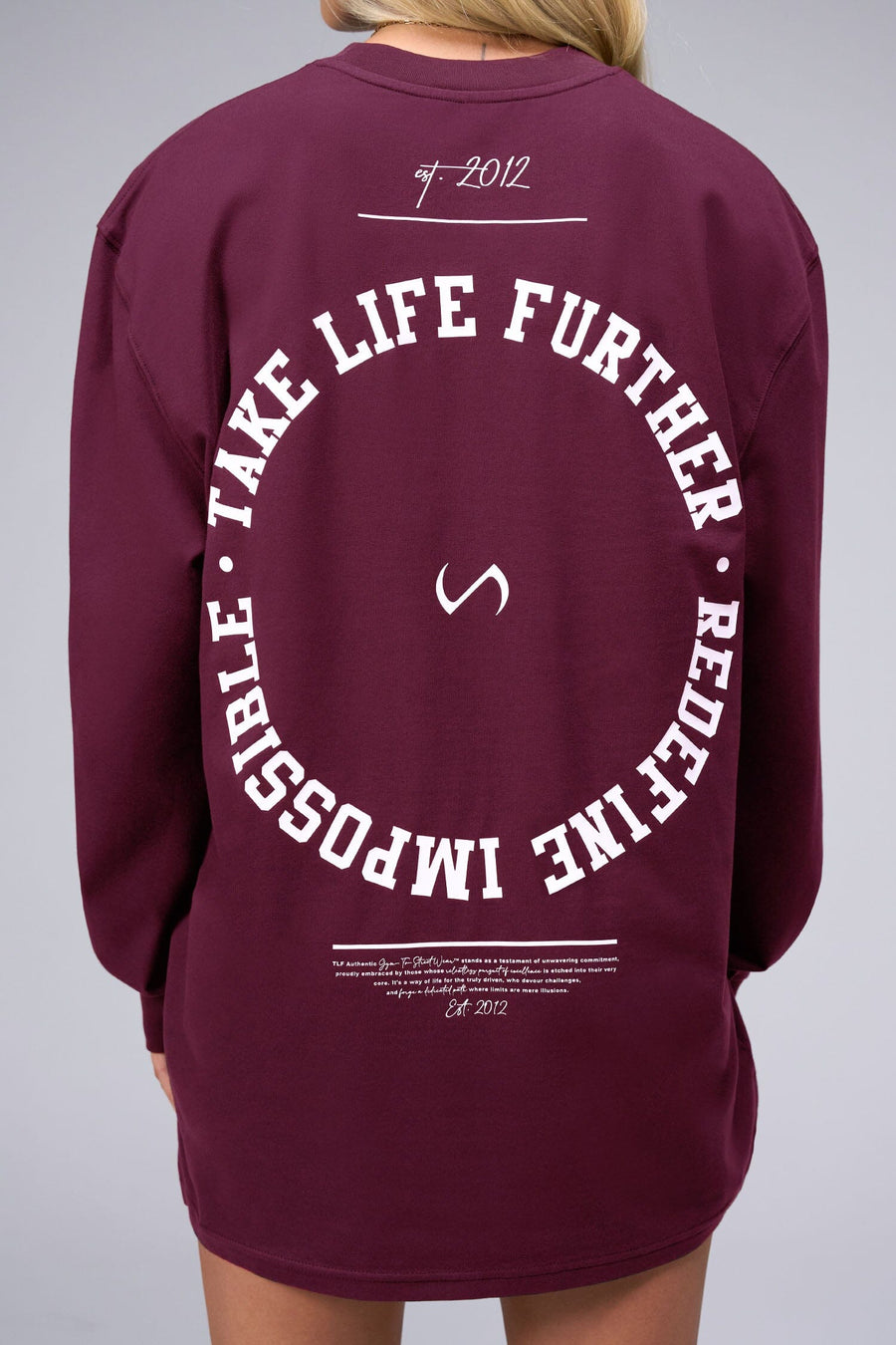 Back View of Red the TLF Redefine Original Cotton Luxe Oversized LS Tee that features a bold back graphic in an oversized fit. 