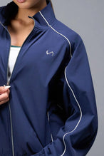 Detail Front View of Blue TLF Track Jacket (Women’s GTS Gym-To-Street Edition) with mesh lining, reflective piping, and premium trims.