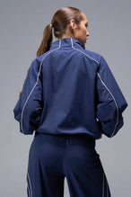 Back View of Blue TLF Track Jacket (Women’s GTS Gym-To-Street Edition) with mesh lining, reflective piping, and premium trims.