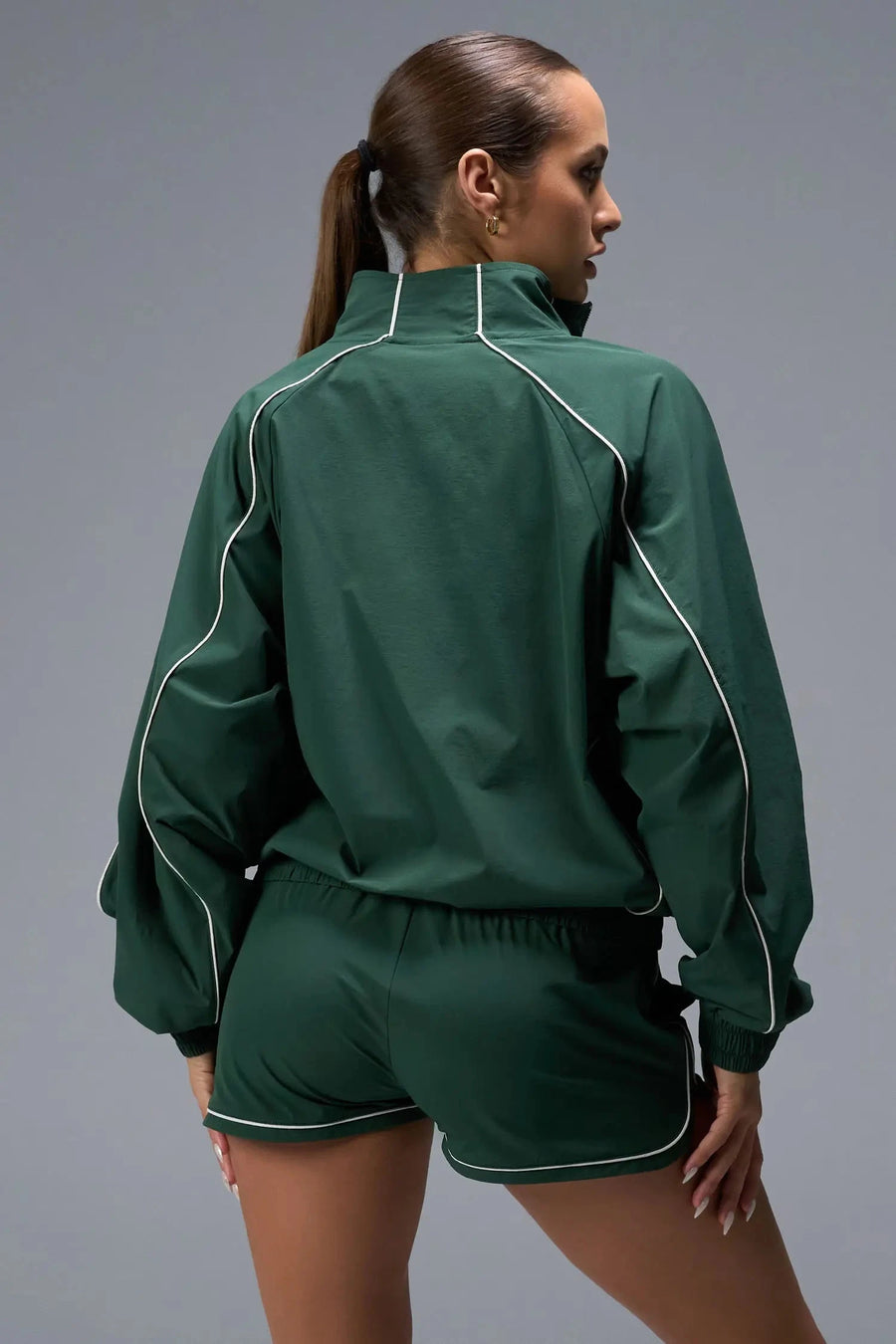 Back View of Green TLF Track Jacket (Women’s GTS Gym-To-Street Edition) with mesh lining, reflective piping, and premium trims.