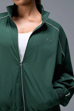 Detail Front View of Green TLF Track Jacket (Women’s GTS Gym-To-Street Edition) with mesh lining, reflective piping, and premium trims.