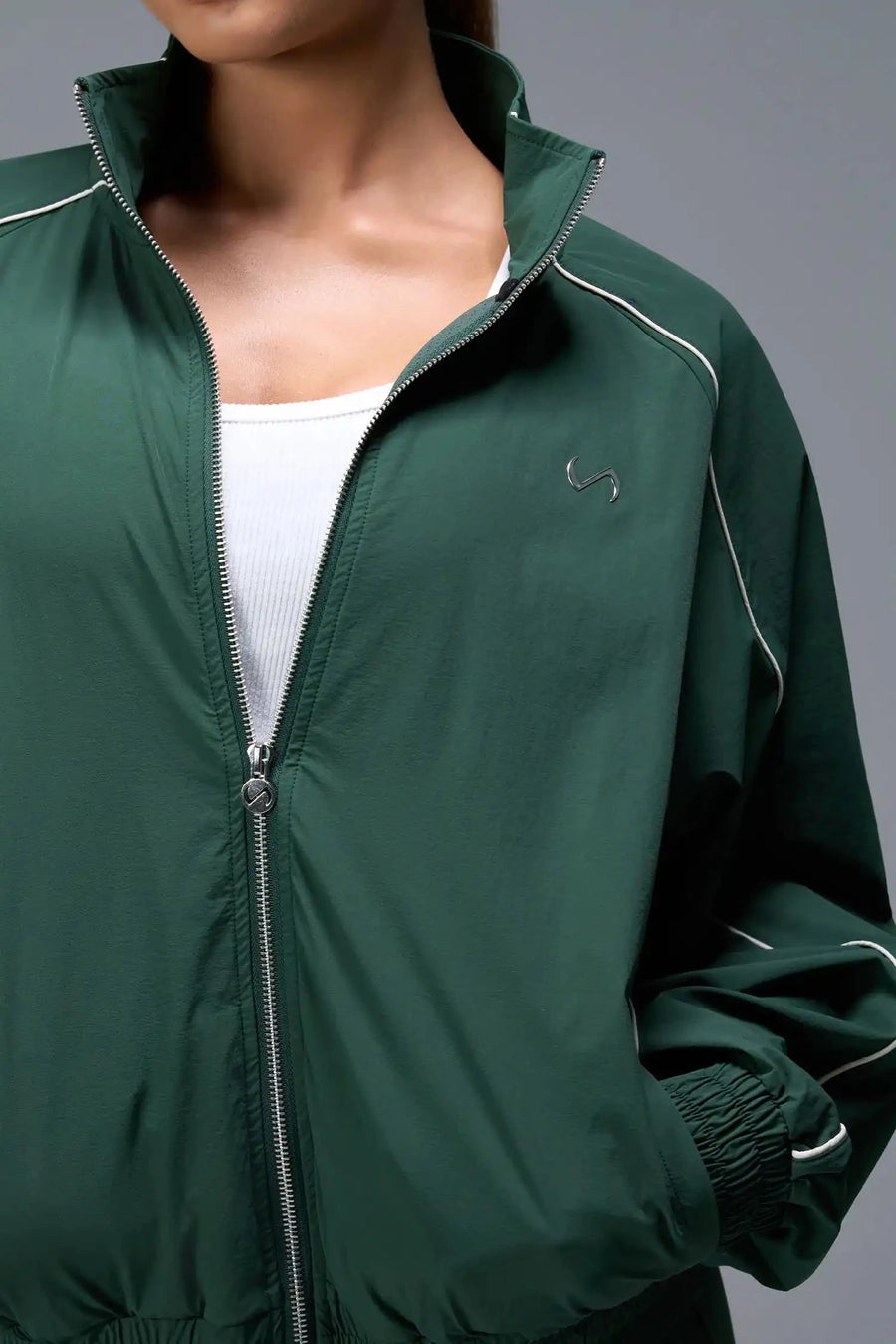 Detail Front View of Green TLF Track Jacket (Women’s GTS Gym-To-Street Edition) with mesh lining, reflective piping, and premium trims.