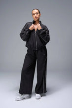 Front View of Black TLF Track Jacket (Women’s GTS Gym-To-Street Edition) with mesh lining, reflective piping, and premium trims.