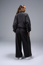 Back View of Black TLF Track Jacket (Women’s GTS Gym-To-Street Edition) with mesh lining, reflective piping, and premium trims.