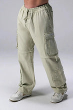 Front View of Green the TLF Zip off cargo pants featuring side cargo pockets and a zip off design that transforms them into shorts