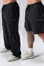 Side View of Black the TLF Zip off cargo pants featuring side cargo pockets and a zip off design that transforms them into shorts